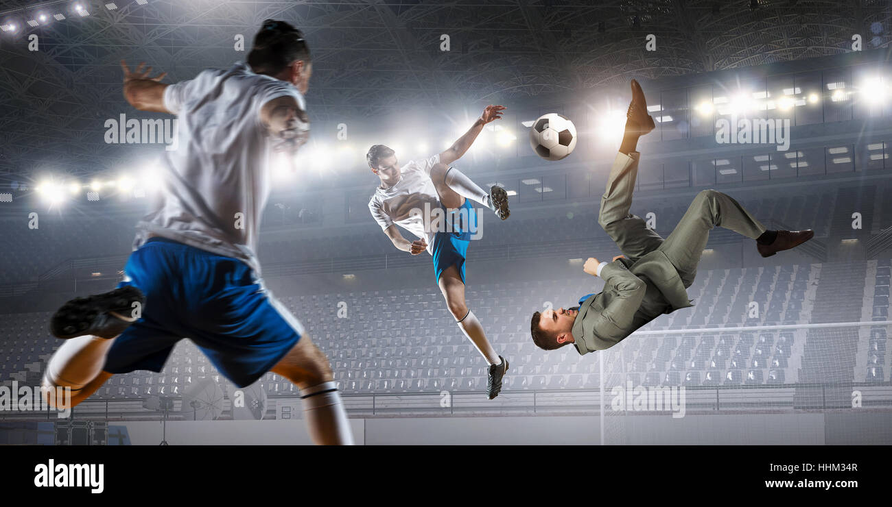 Football player at stadium fighting for ball. Mixed media Stock Photo ...