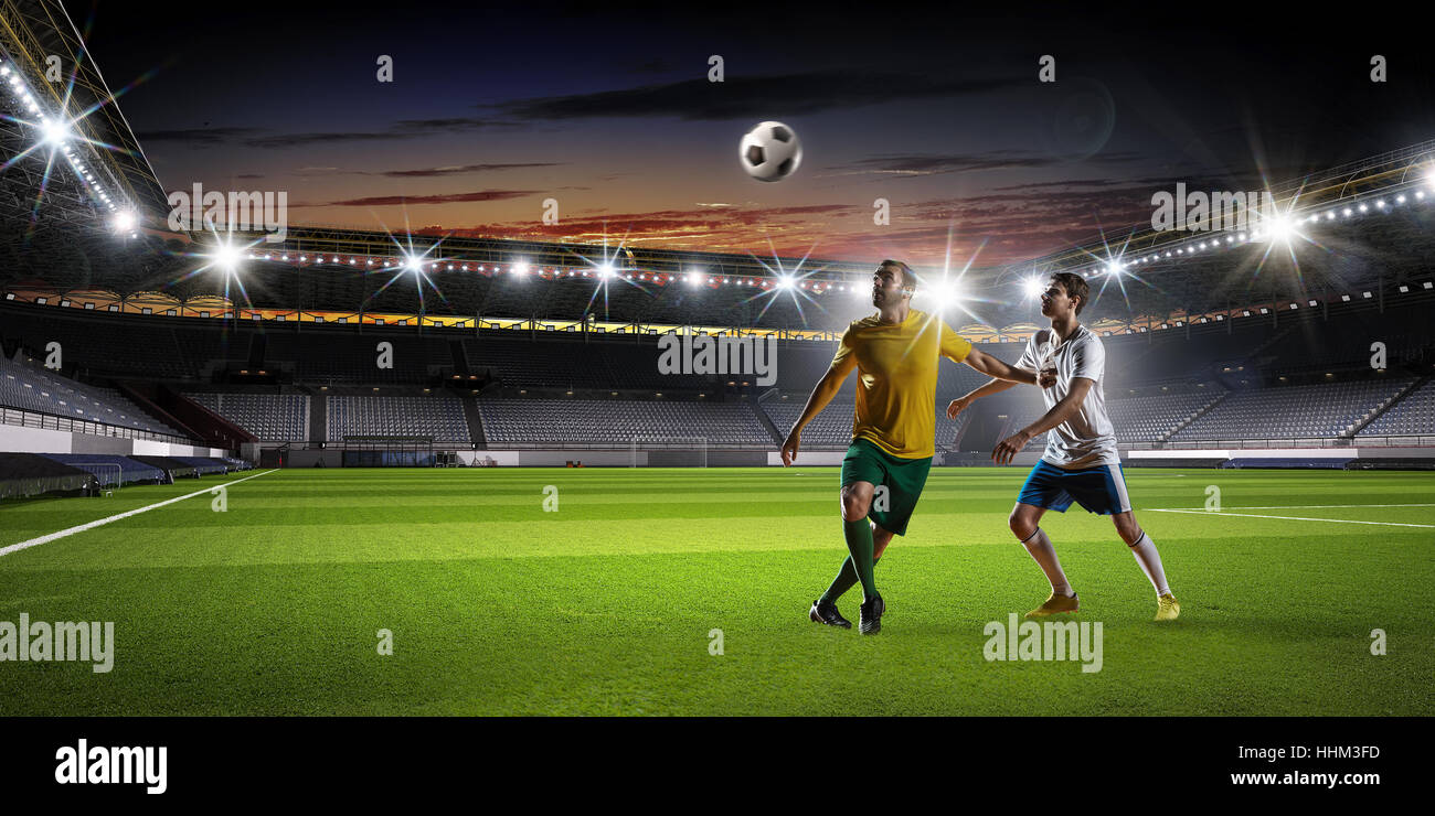 Soccer players in action on stadium fighting for ball. Mixed media ...