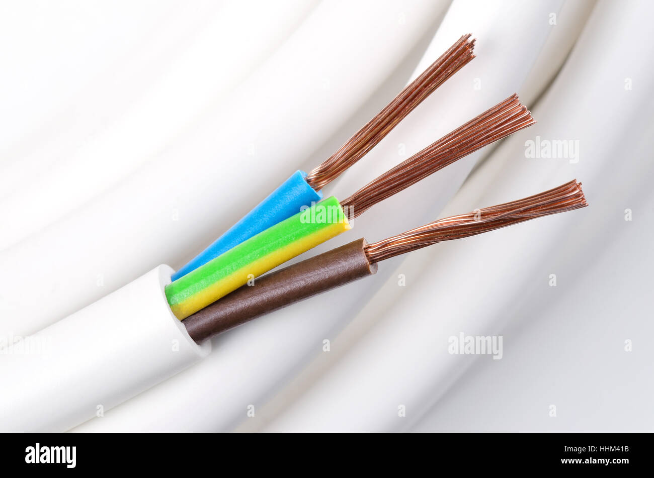 Electrical power cable macro photo. IEC standard color code. Cross-section with cable jacket, wire insulation. Stock Photo