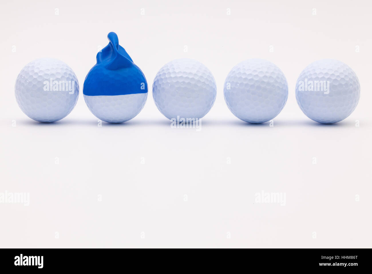 White golf balls with funny cap on the white background. Funny golf concept Stock Photo Alamy