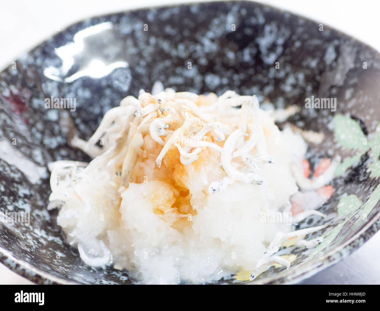 Japanese cuisine, grated Japanese radish and boiled young sardines with soy sauce in the bowl Stock Photo