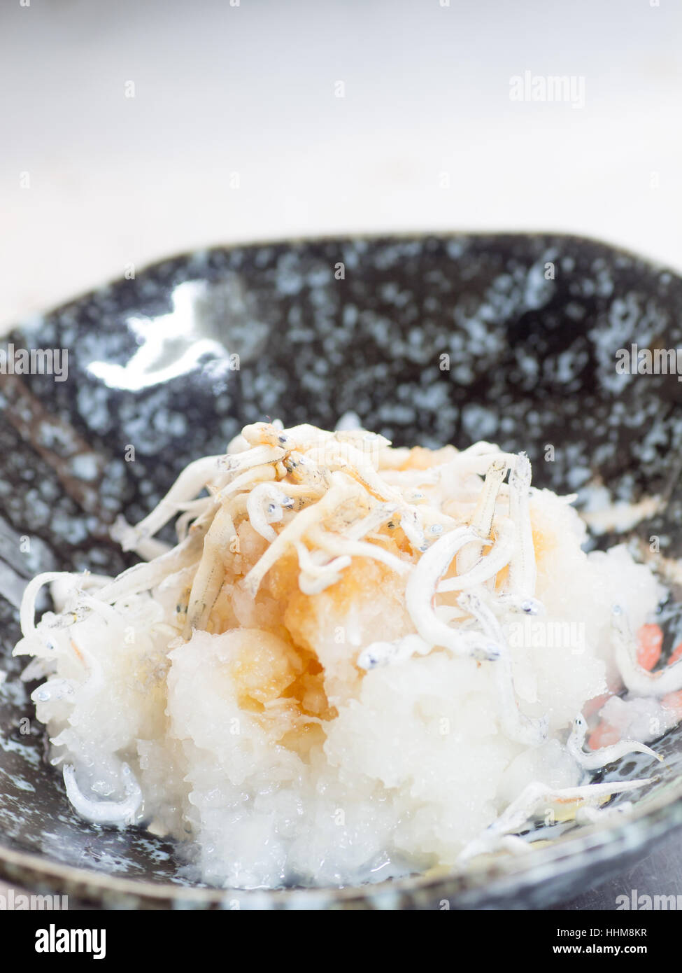Japanese cuisine, grated Japanese radish and boiled young sardines with soy sauce in the bowl Stock Photo