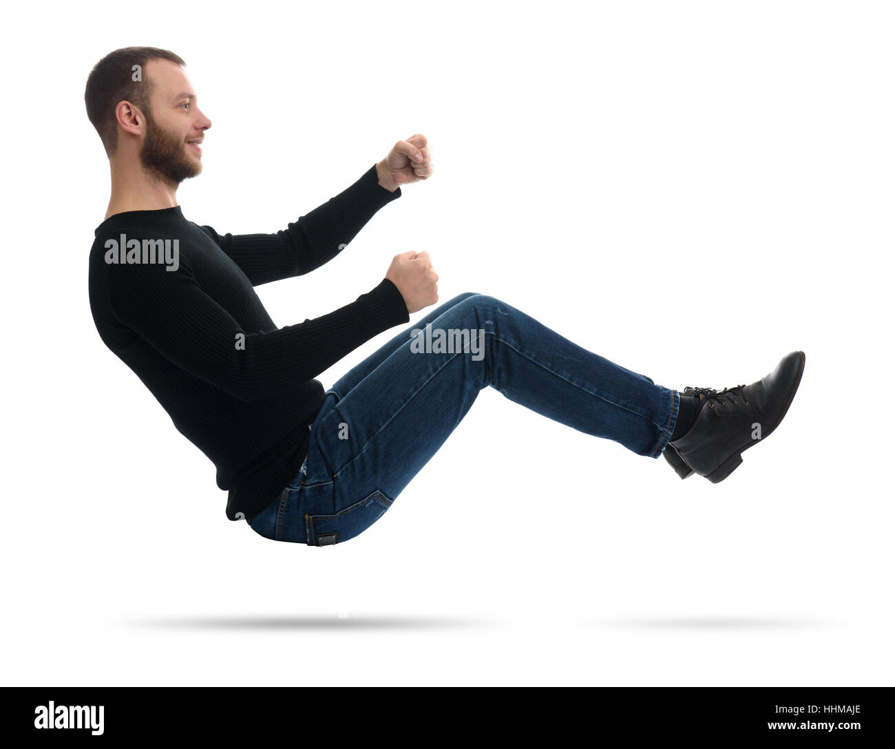 guy drives an imaginary car. man in the air. Isolated on white Stock Photo