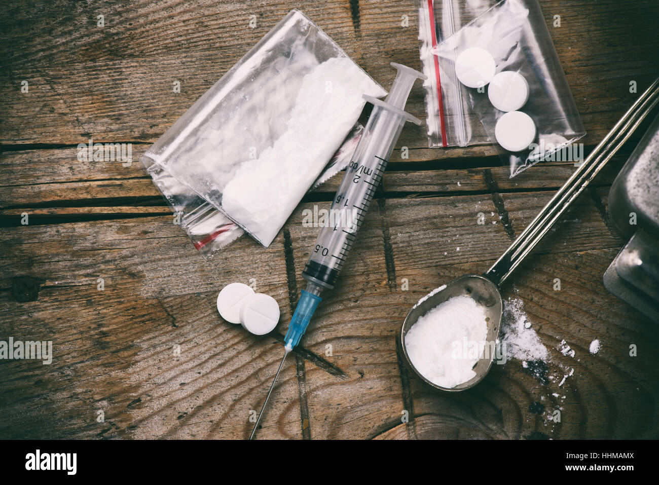 Drug, syringe and heroin on grunge wooden background Stock Photo