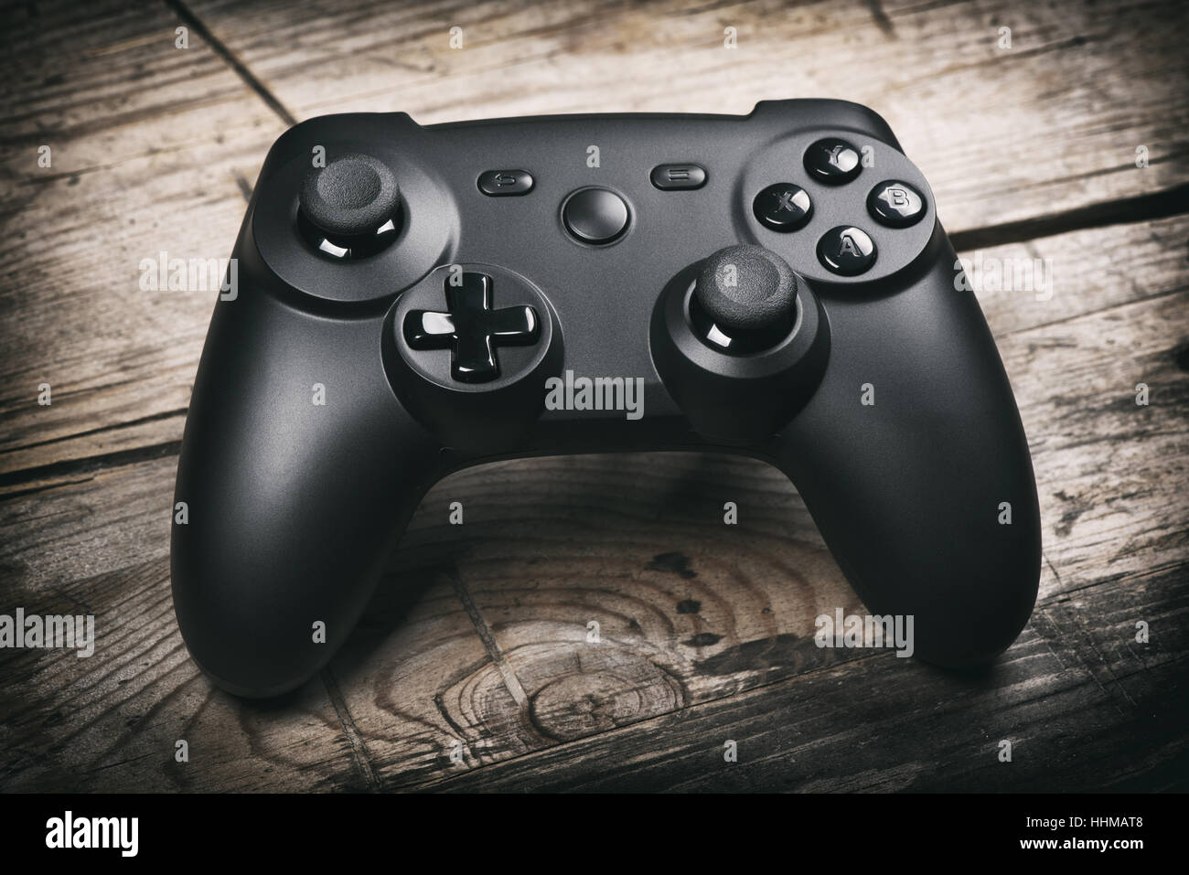 video game controller on a wooden table. joystick Stock Photo