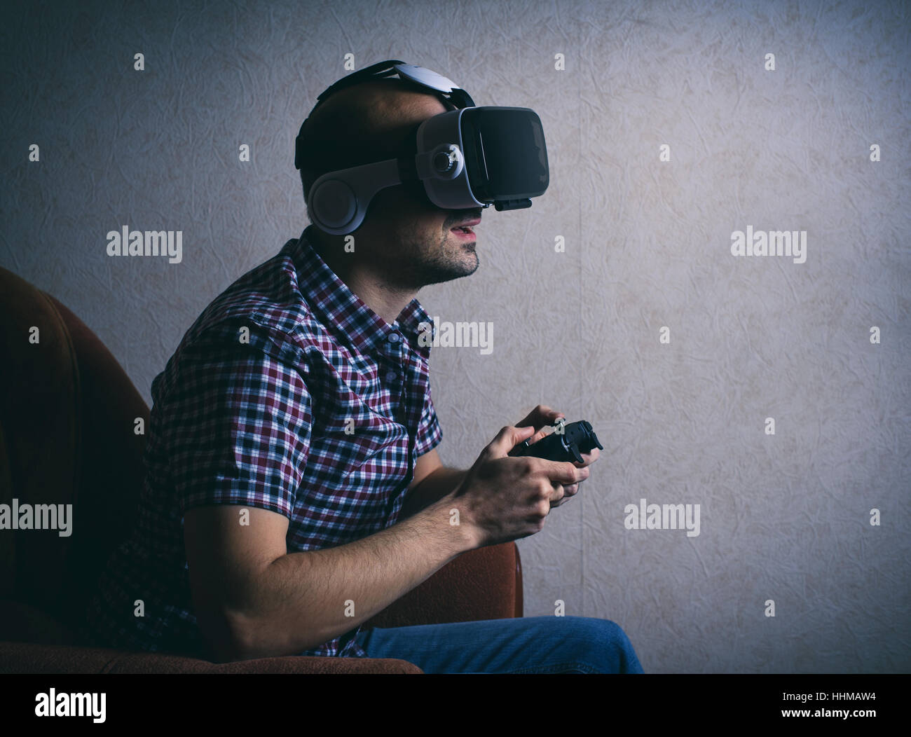 man playing computer game at home in virtual glasses Stock Photo