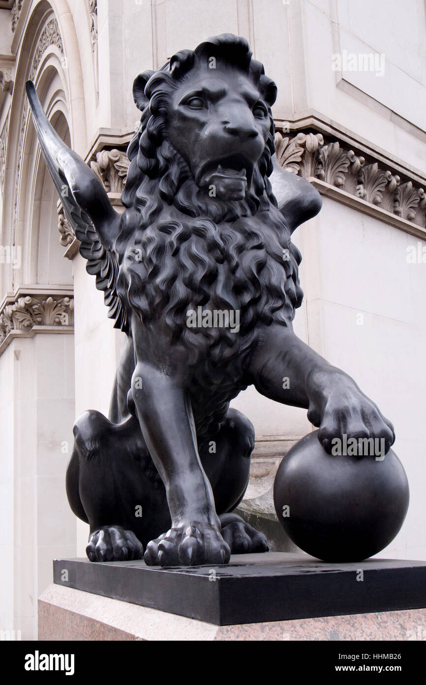 Bronze statue of a wingedLion with one paw on a globe on Holborn