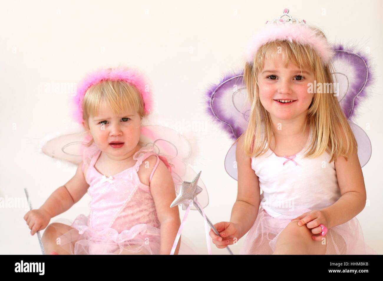 Children dressed as fairies in fairy costumes, Baby sister fairies making magic wish upon a star