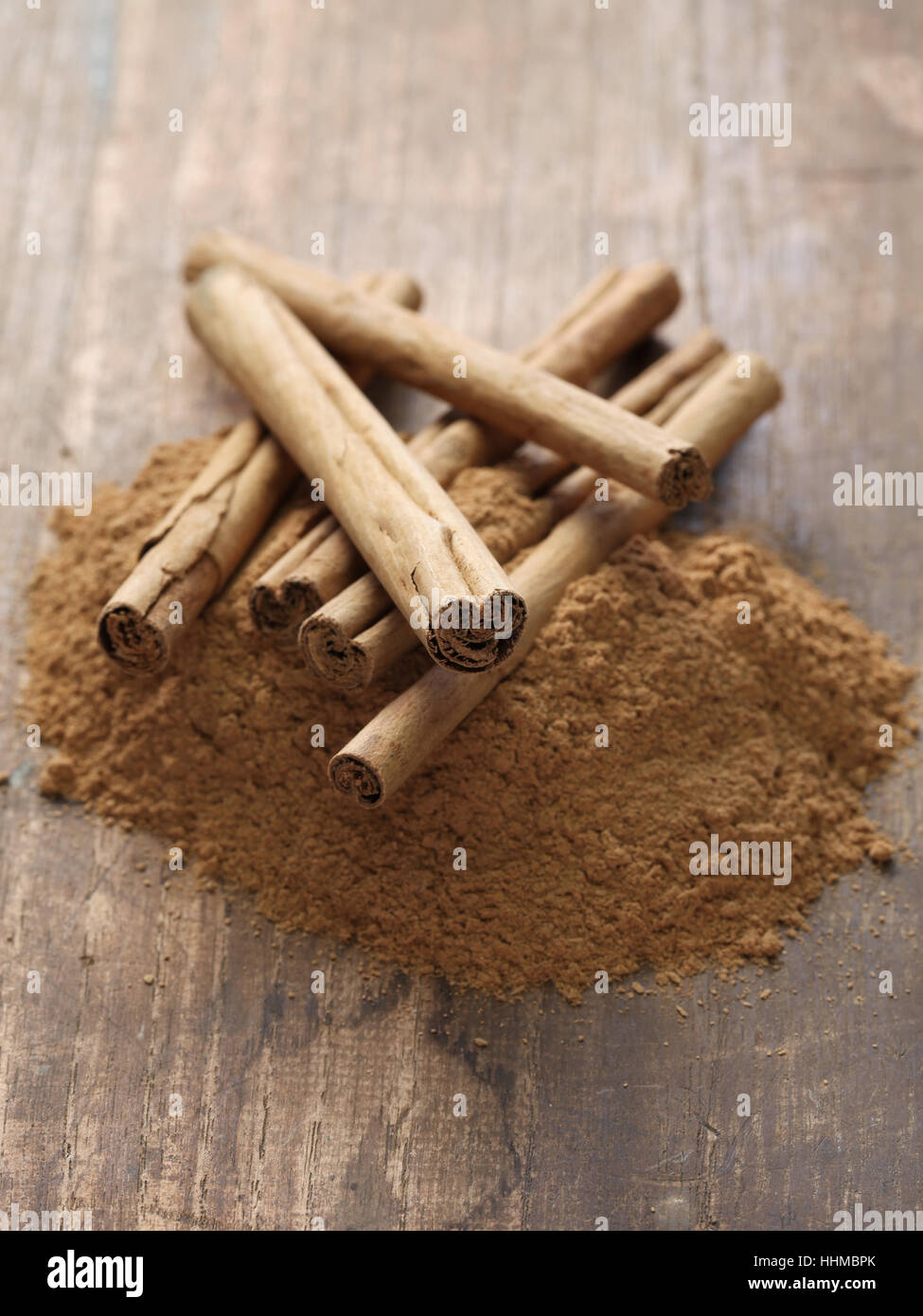ceylon cinnamon sticks and powder on wooden background Stock Photo