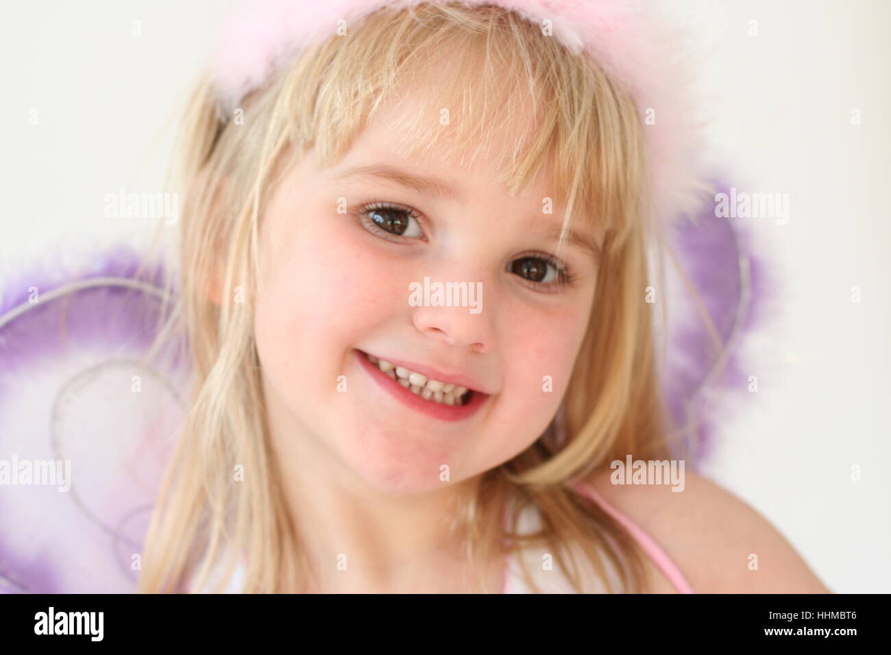 Child dressed as a fairy smiling, Pretty angel fairy, fairy costume, childhood innocence concept, fairy wings, best life, joy concept Stock Photo