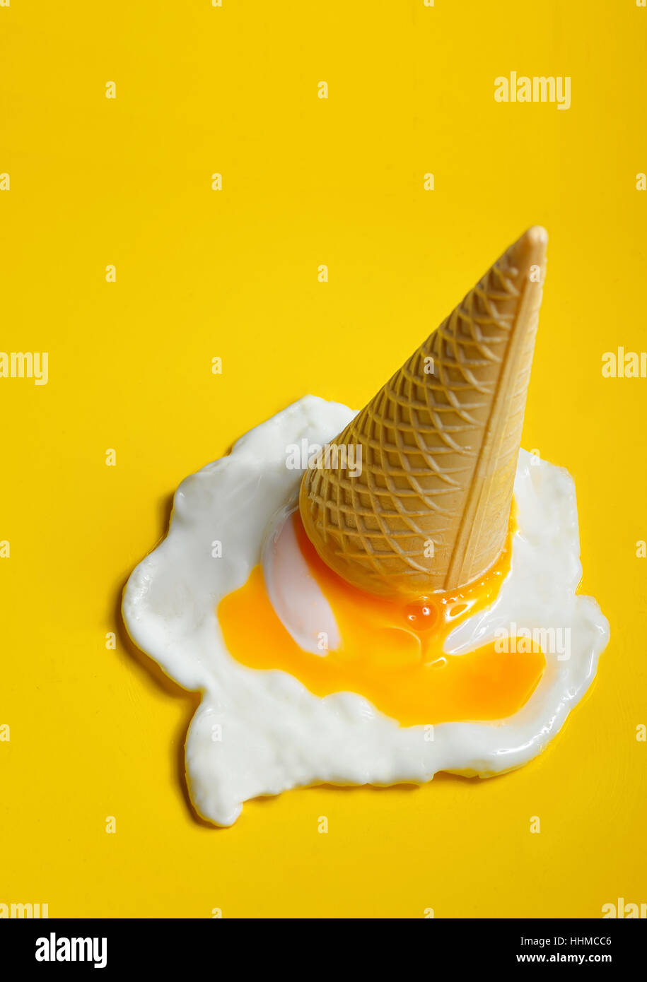 Ice cream cone dropped concept with fried egg Stock Photo