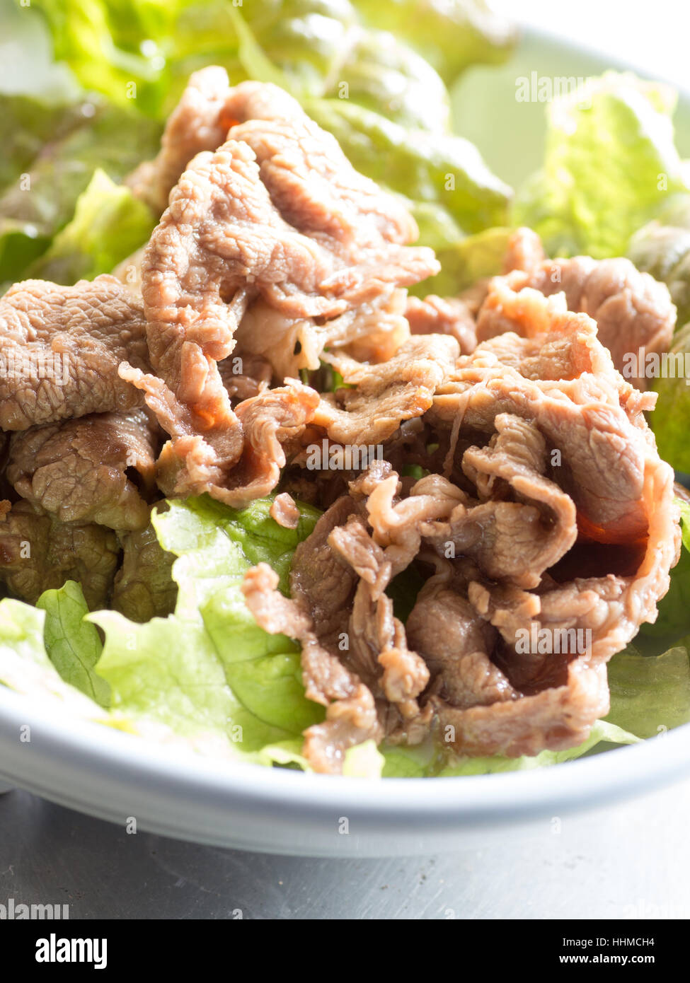 Japanese cuisine, grilled lean beef with lettuce on the dish Stock Photo
