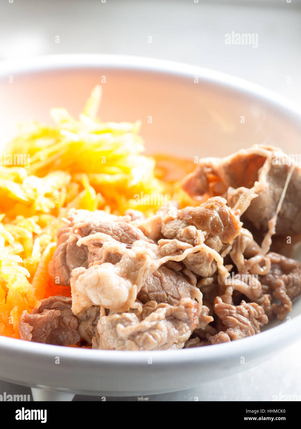 Japanese cuisine, grilled lean beef with shredded carrot salad on the dish Stock Photo