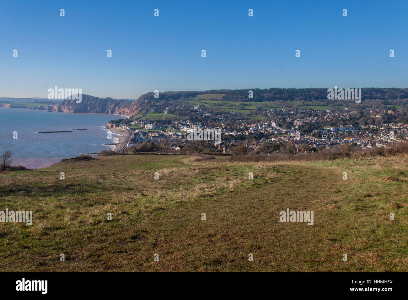 Sidmouth. View over the town and seafront at Sidmouth, Devon, from Salcombe Cliff Hill, taking in the red sandstone cliffs of the Jurassic Stock Photo