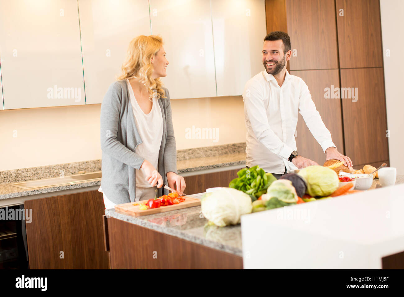 Young loving couple  preparing  tasty meal in a modern kitchen Stock Photo