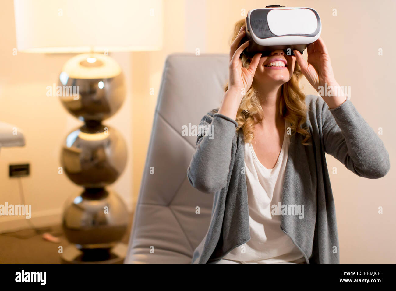 Woman wearing virtual reality goggles in the room Stock Photo