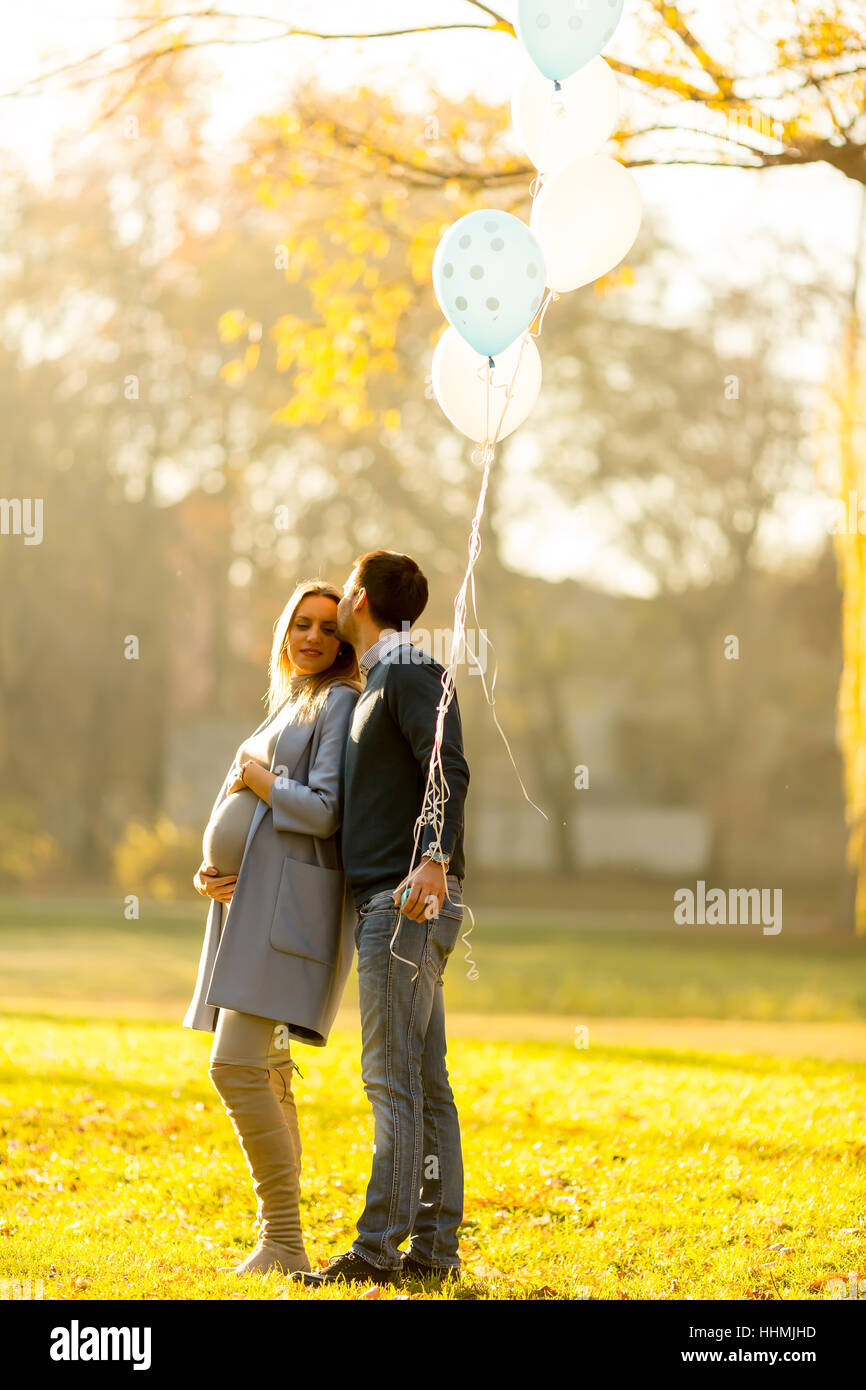 Happy loving couple with balloons in the park Stock Photo - Alamy