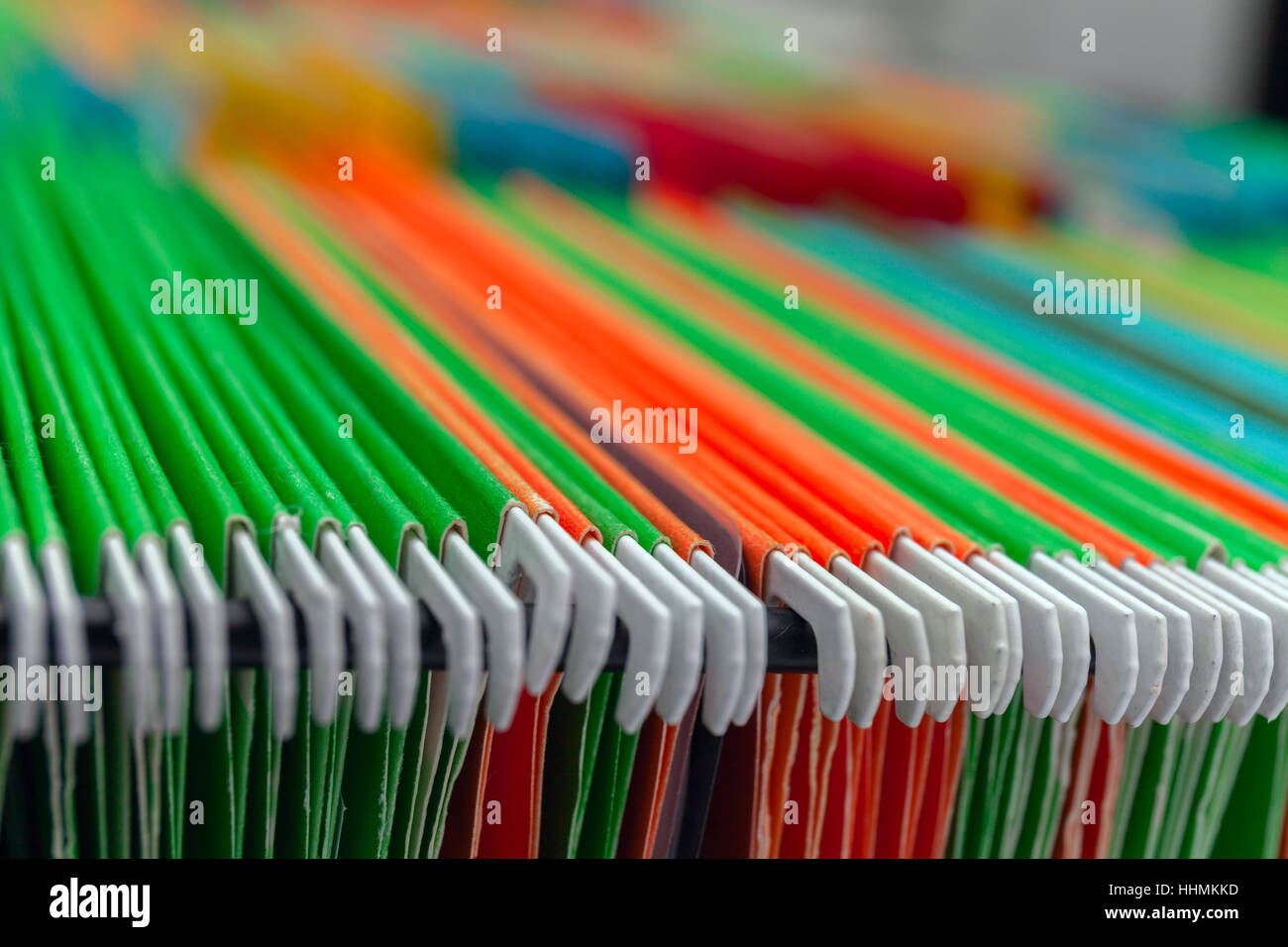 Abstract background colorful hanging file folders in drawer. Stock Photo