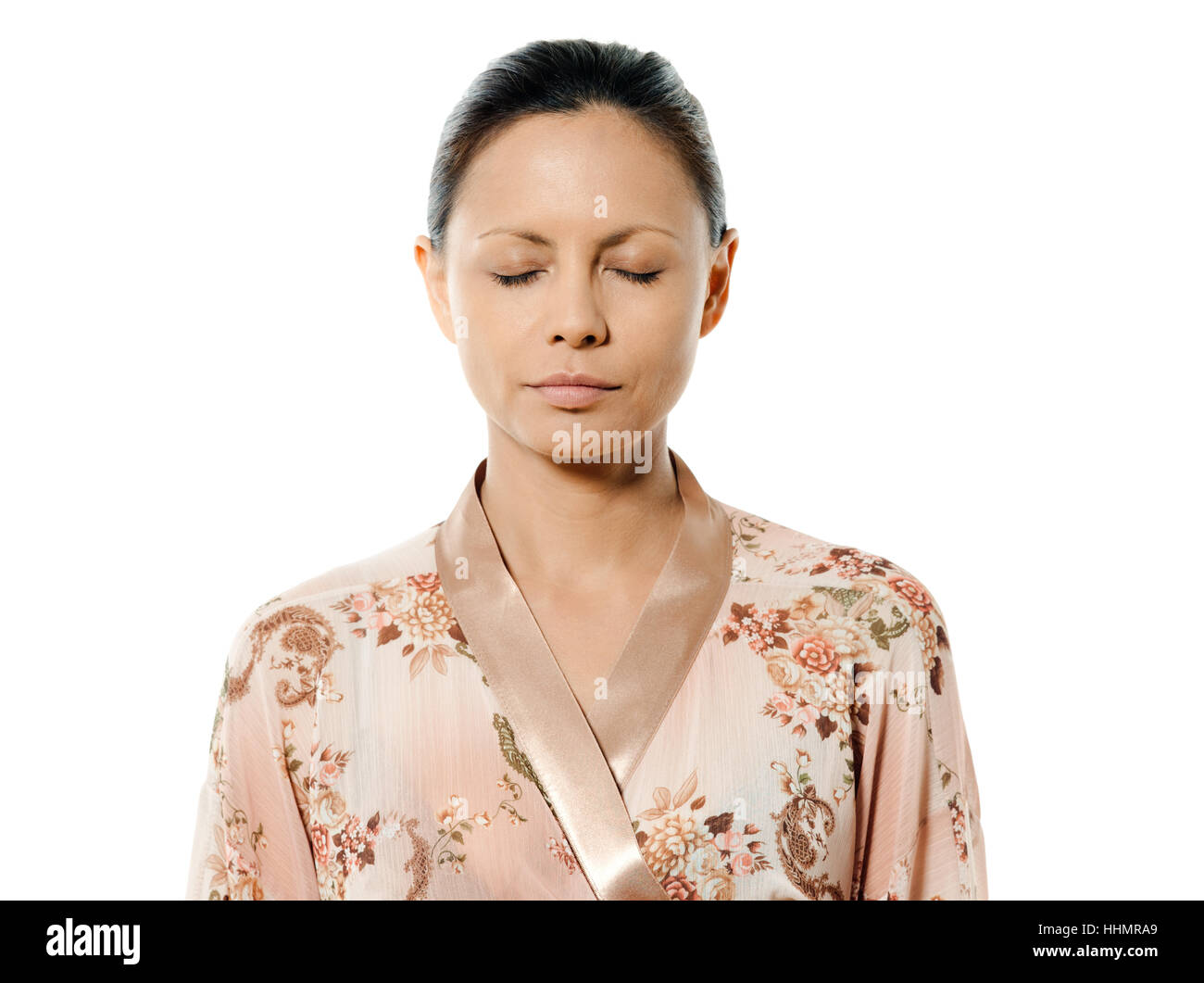 Closeup portrait of Asian woman with eyes closed in studio isolated on ...