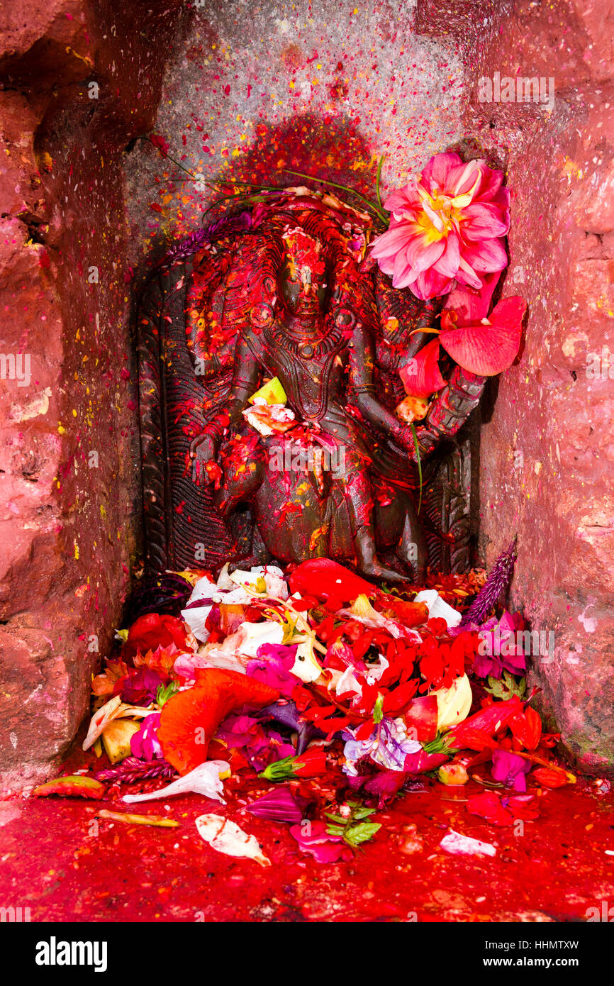 Small statue of god Kaalratri outside Khadga Devi Temple, colourfully decorated, Hindu festival Darsain, Bandipur Stock Photo