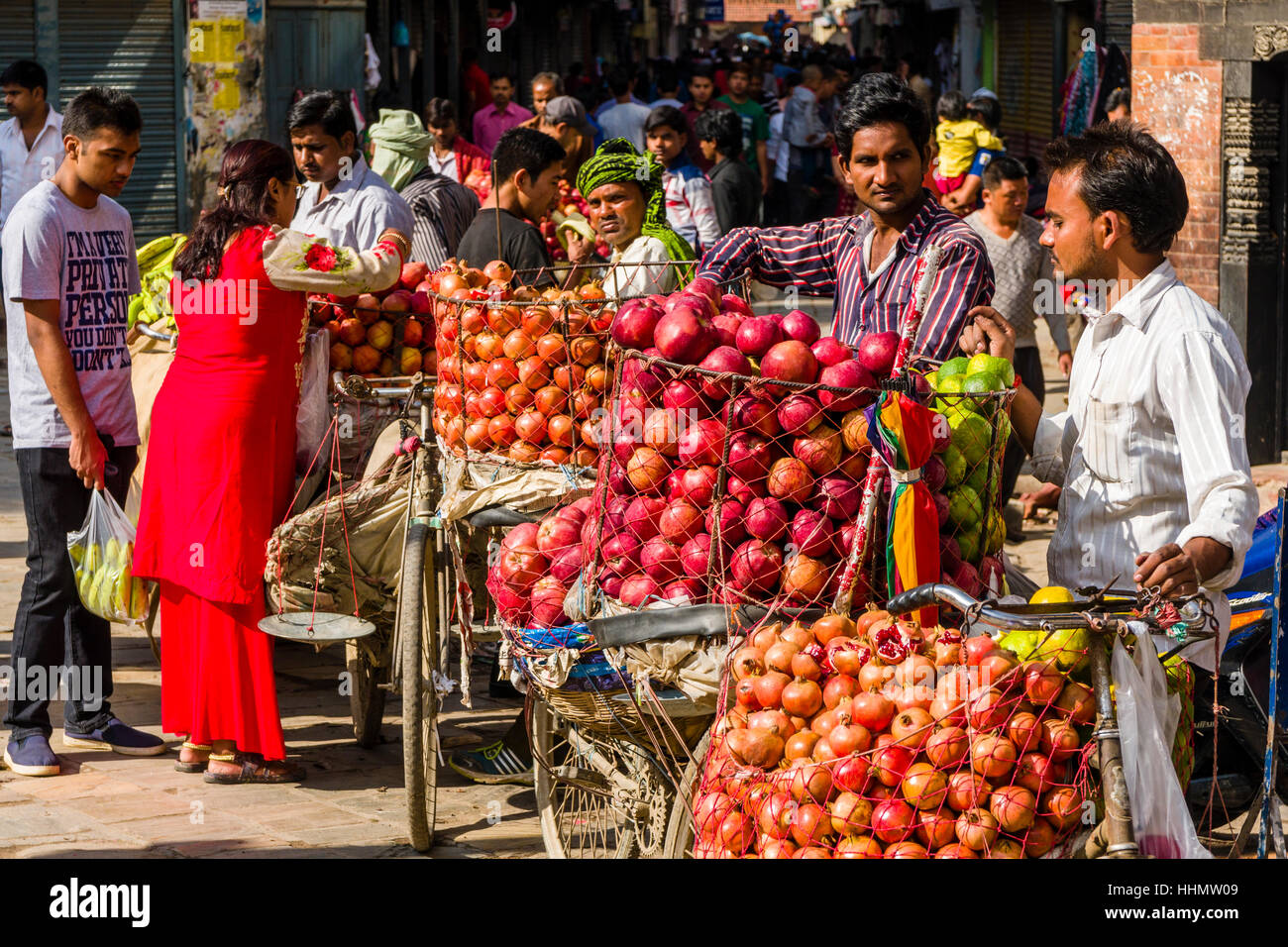Fruit sellers, using bicycles, are offering apples and oranges on Indra Chowk market square, Kathmandu, Kathmandu District Stock Photo