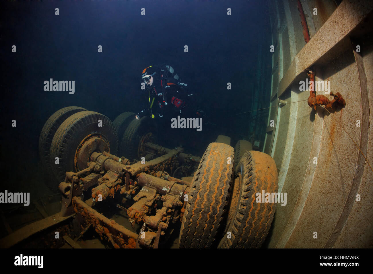 Diver looking at lorry in hold, El Arish or El Arish El-Tor shipwreck, sunken car ferry, Port Safaga, Red Sea, Egypt Stock Photo
