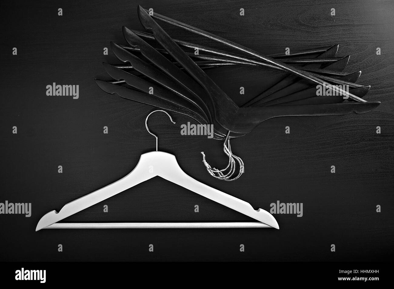 White hanger and a few black hangers, background, abstract Stock Photo
