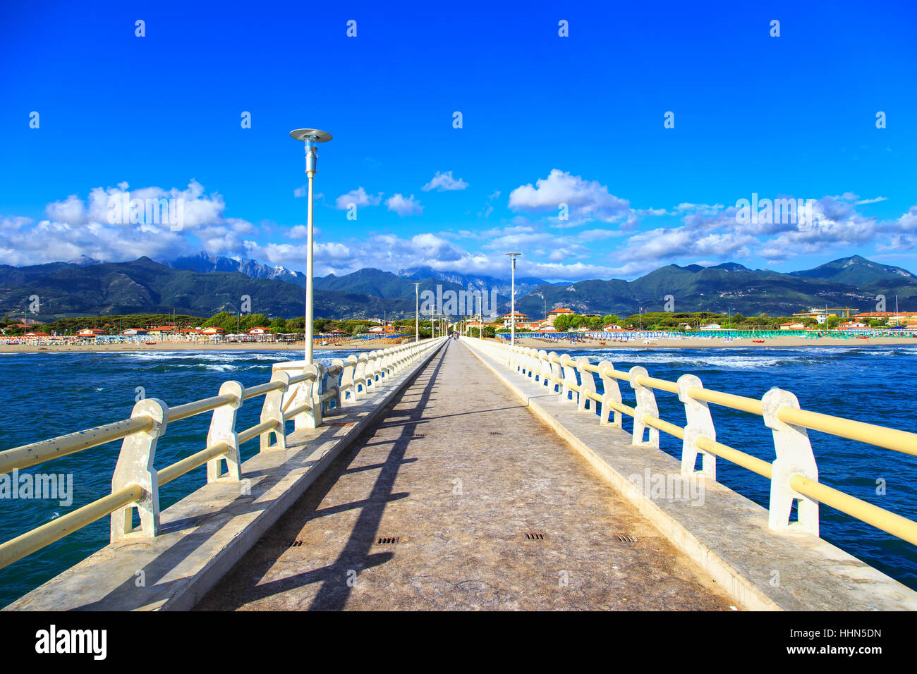 Pier footpath promenade, beach and Apuane mountains in Forte dei Marmi Versilia Tuscany Italy Stock Photo
