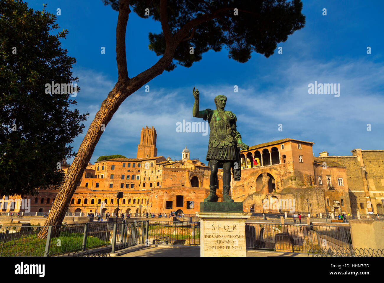 Rome, Italy.  Statue of the Emperor Trajan with Trajan's Forum behind.  The Historic Centre of Rome is a UNESCO World Heritage Site. Stock Photo