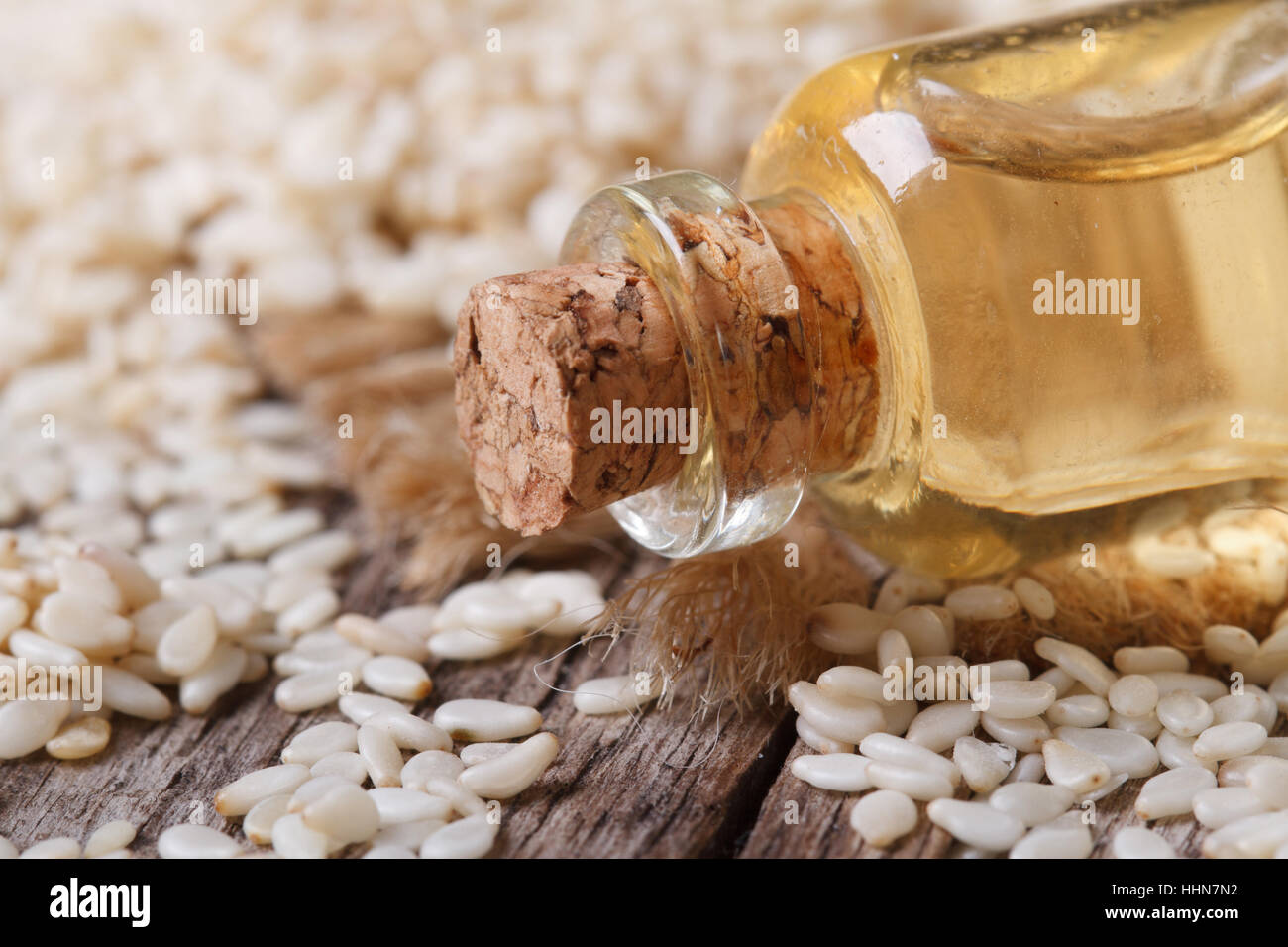 sesame seed oil in a glass bottle with a cork on the table macro horizontal Stock Photo