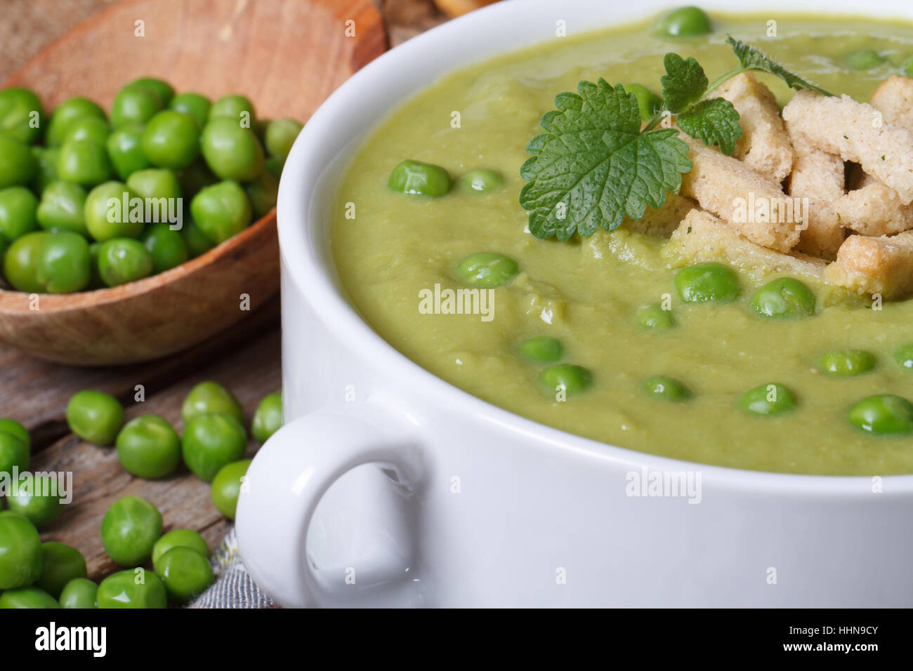 Cream soup of fresh green peas and mint macro. horizontal Stock Photo