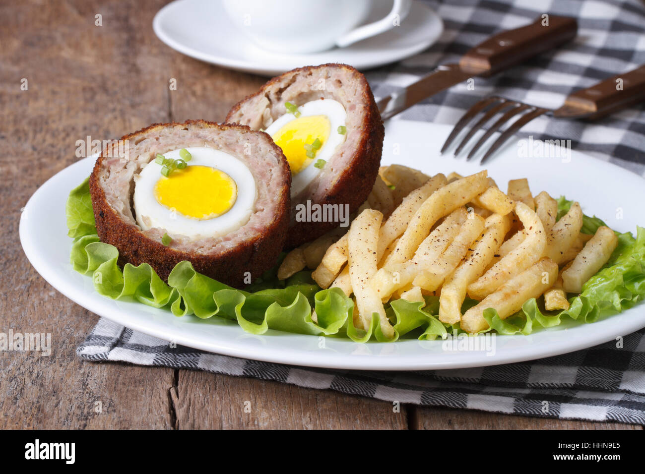 meat stuffed with egg and French fries close-up on a plate on the table. horizontal Stock Photo