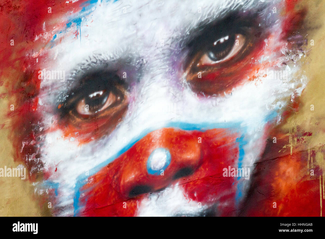 African style painted voodoo red-faced scary clown graffiti, Manchester, UK Stock Photo