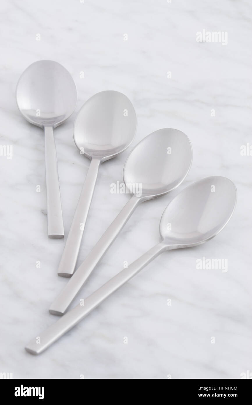 silver spoon set styled on antique carrara marble Stock Photo