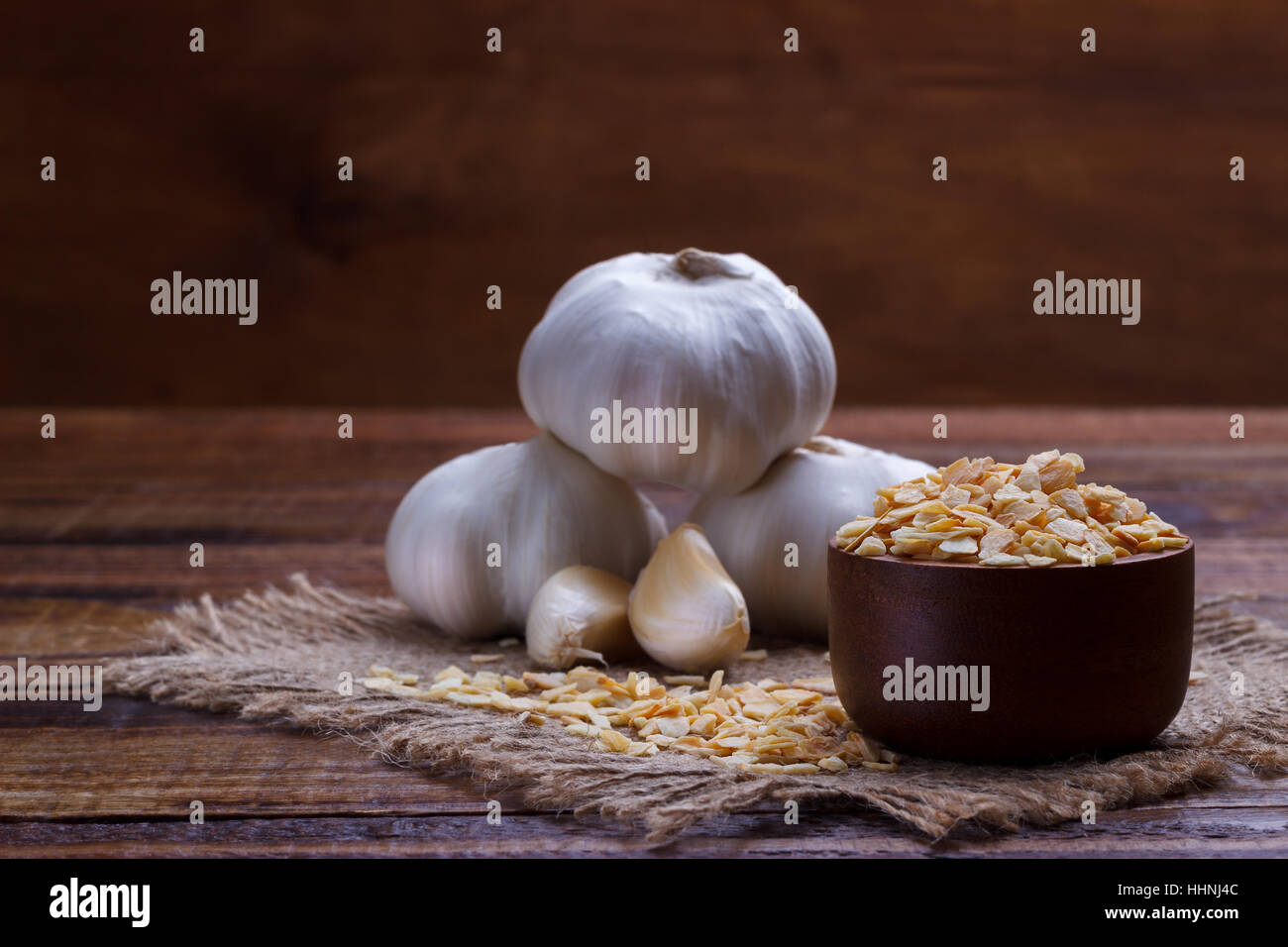 garlic cloves, bulb, flakes and powder on old wooden board Stock Photo