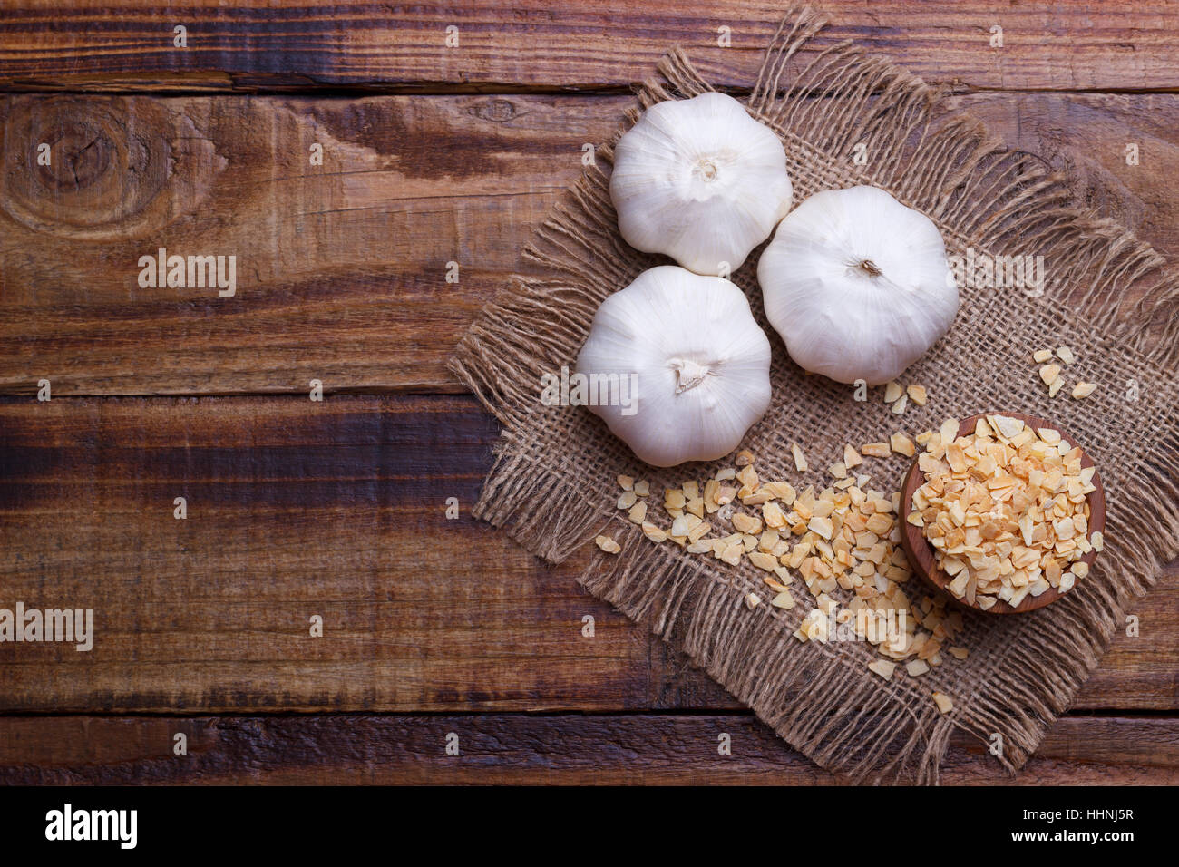 garlic cloves, bulb, flakes and powder on old wooden board Stock Photo