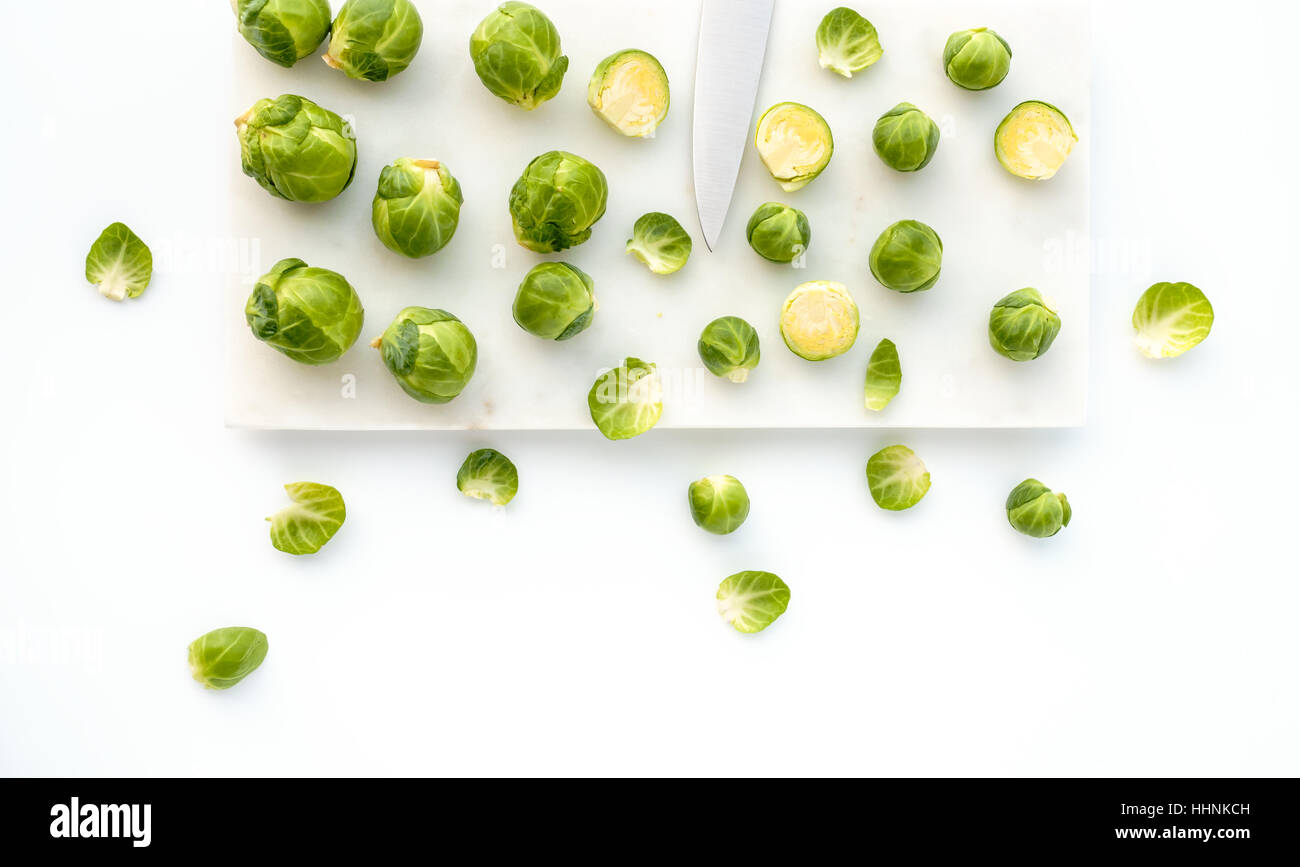 Brussels Sprouts and Knife on White Marble Stock Photo