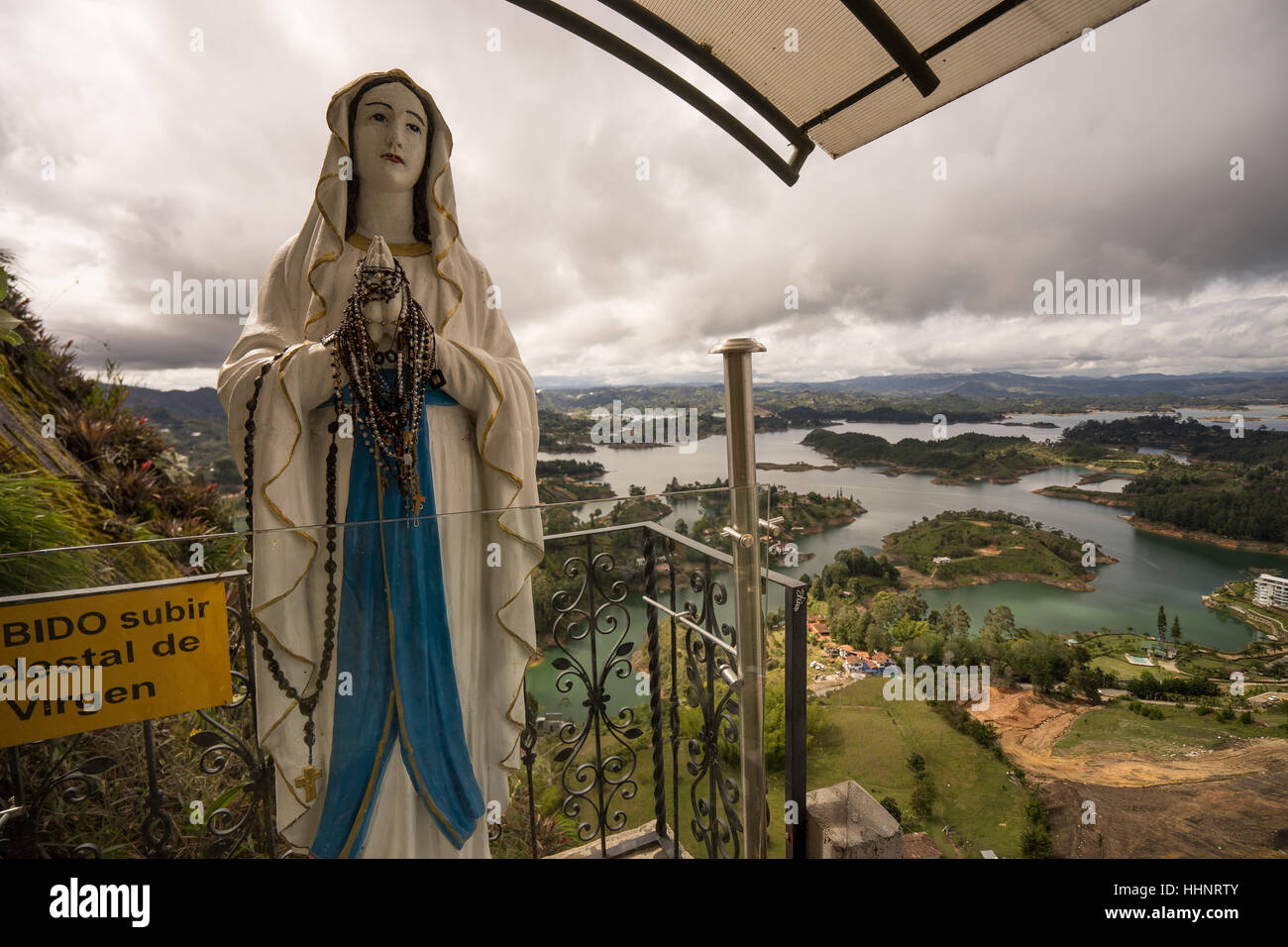 Virgin statue altar at Penon de Guatape Colombia aerial view of a residential area on the shore of the artificial lake Stock Photo