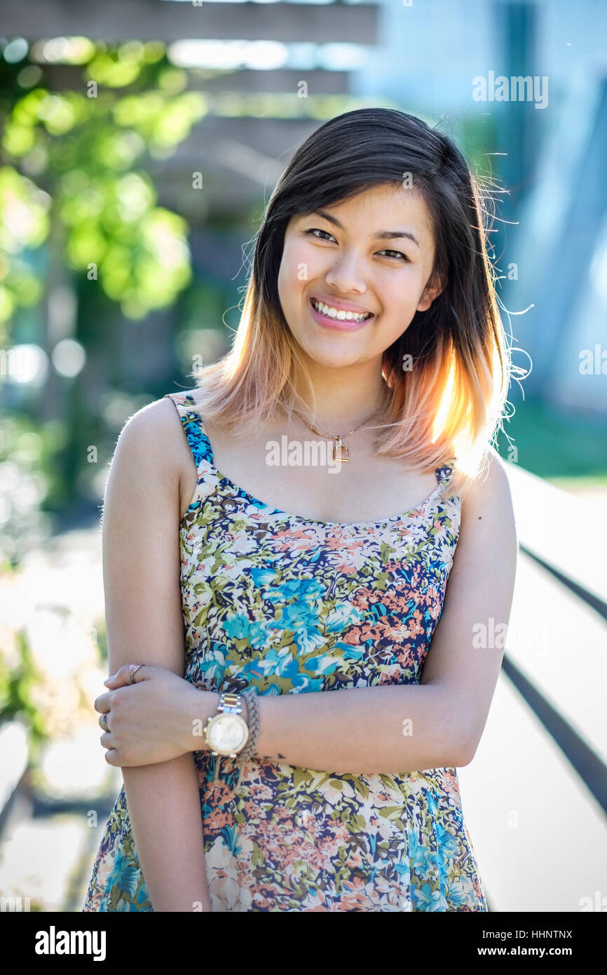 Portrait of smiling Chinese woman wearing dress Stock Photo