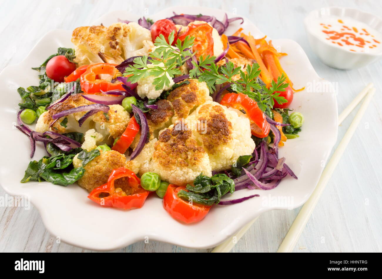 fried cauliflower and mixed vegetables with chopsticks Stock Photo