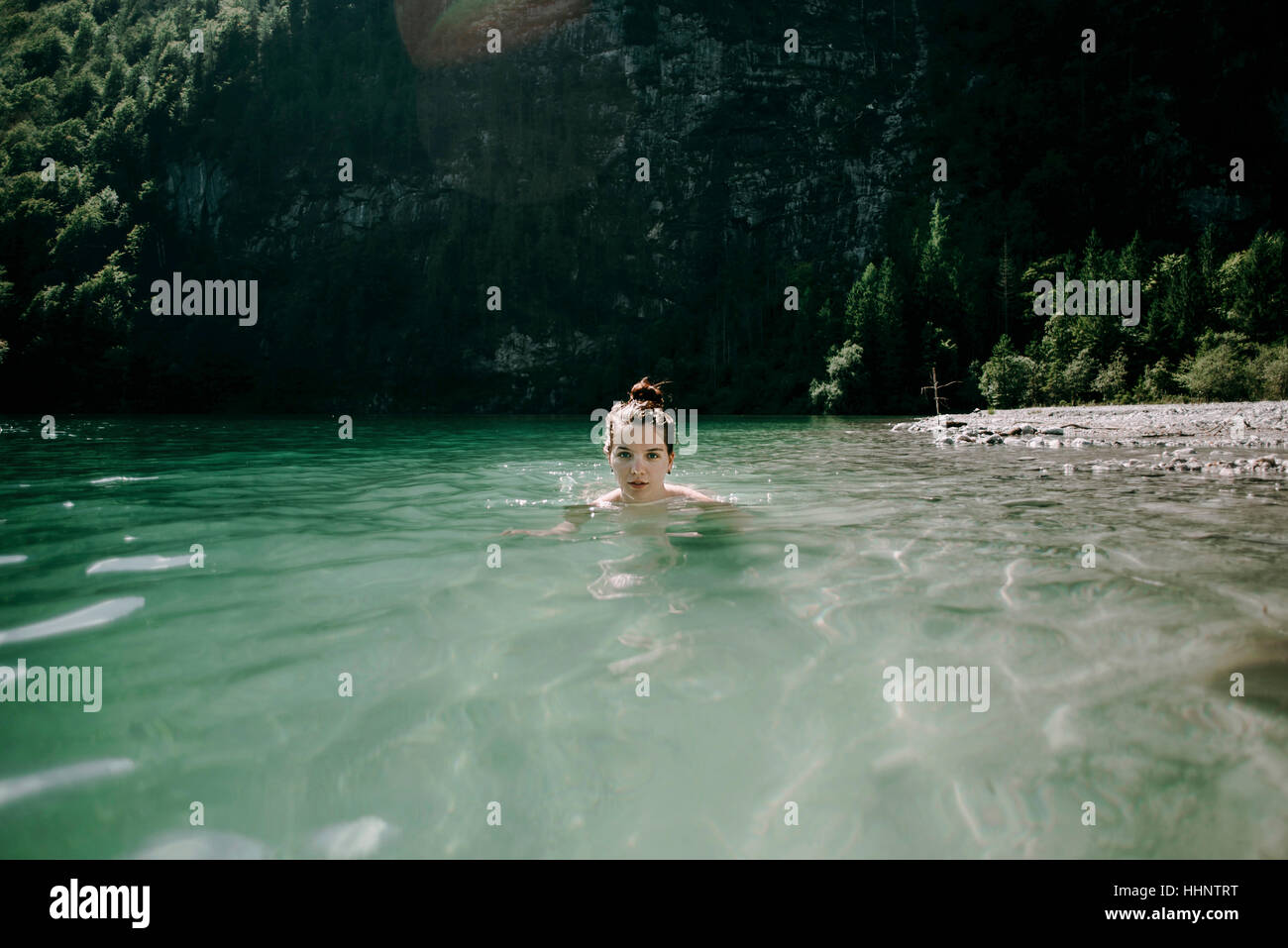 Caucasian woman swimming in mountain lake Stock Photo