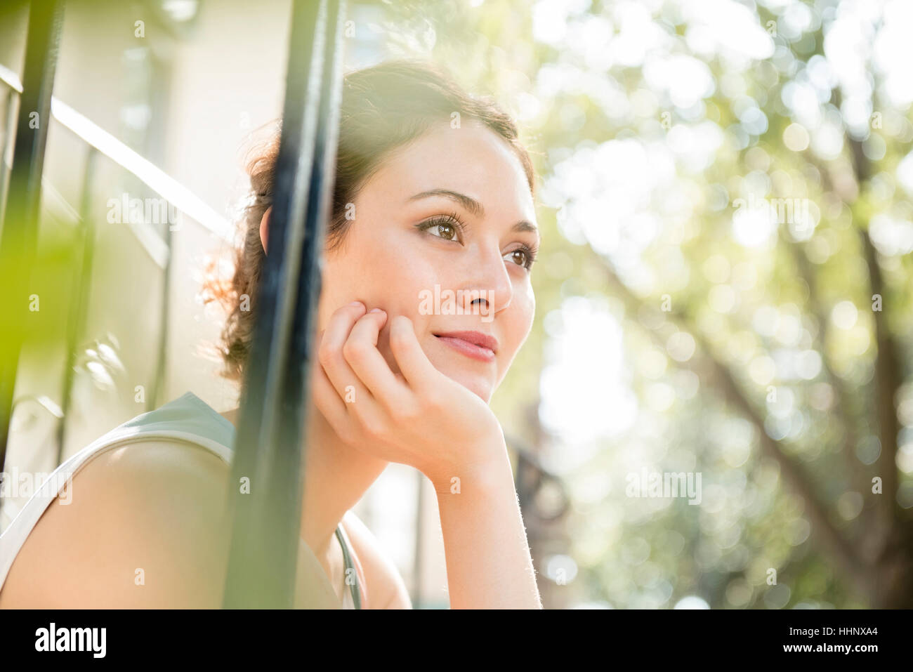 Pensive Thai woman with hand on chin Stock Photo