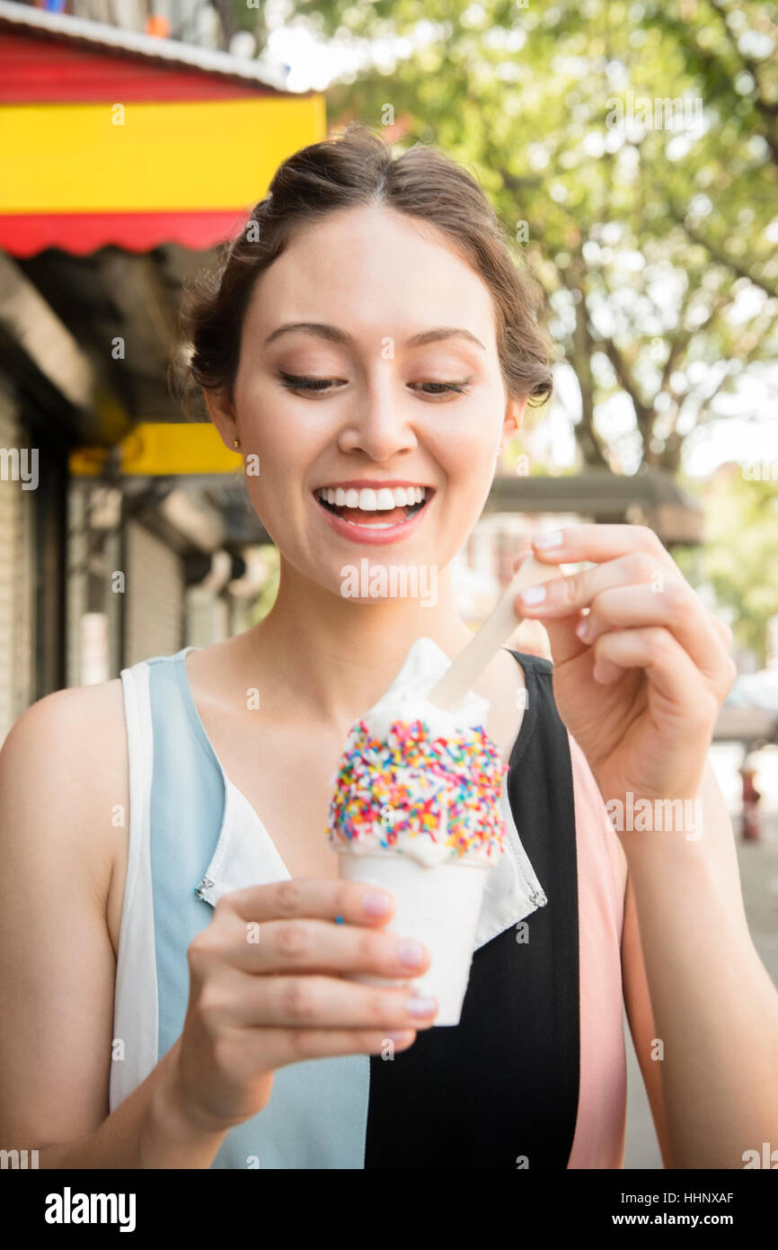 Thai woman eating ice cream in city Stock Photo