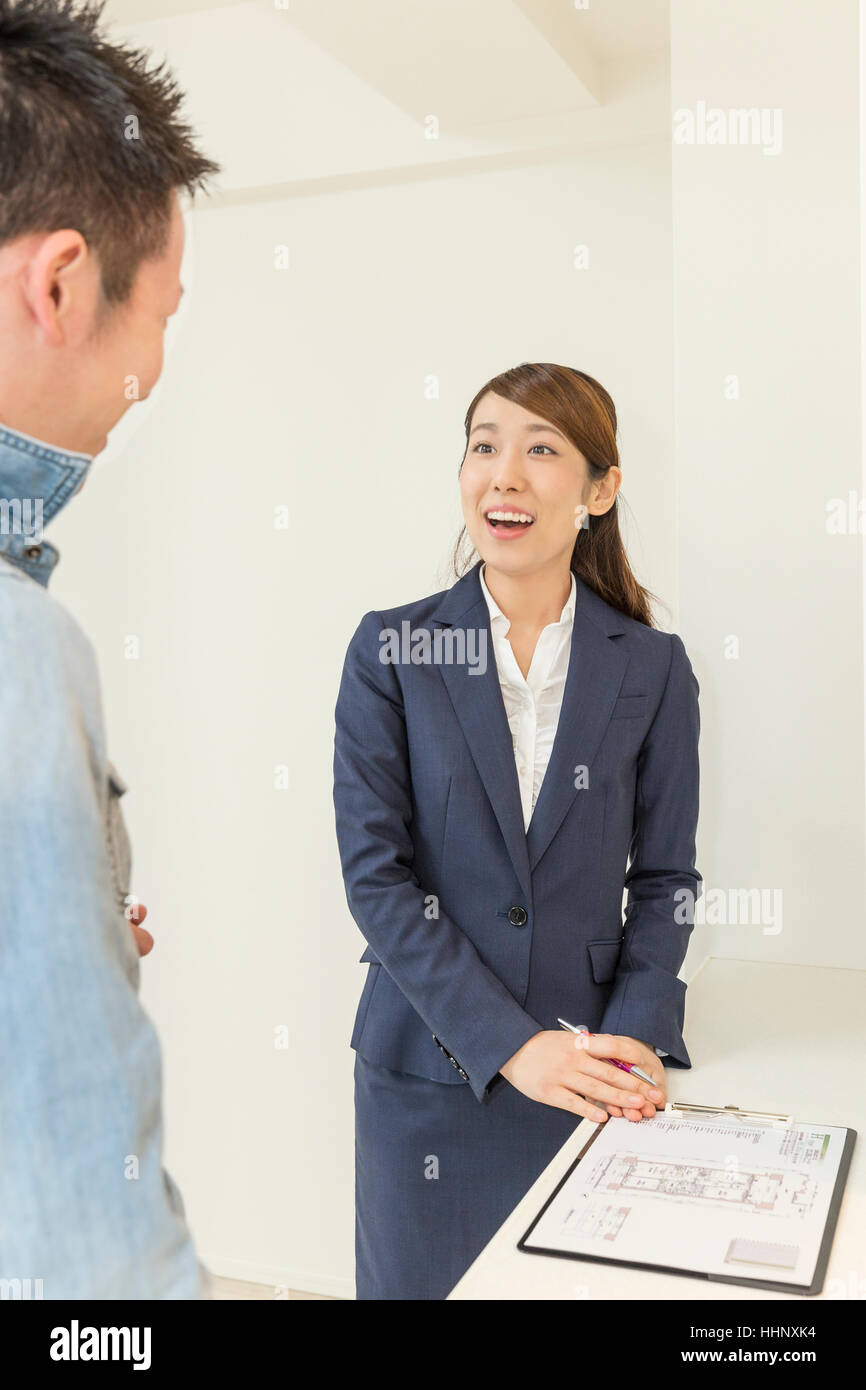 Real Estate Agent Showing Floor Plan to Buyer Stock Photo