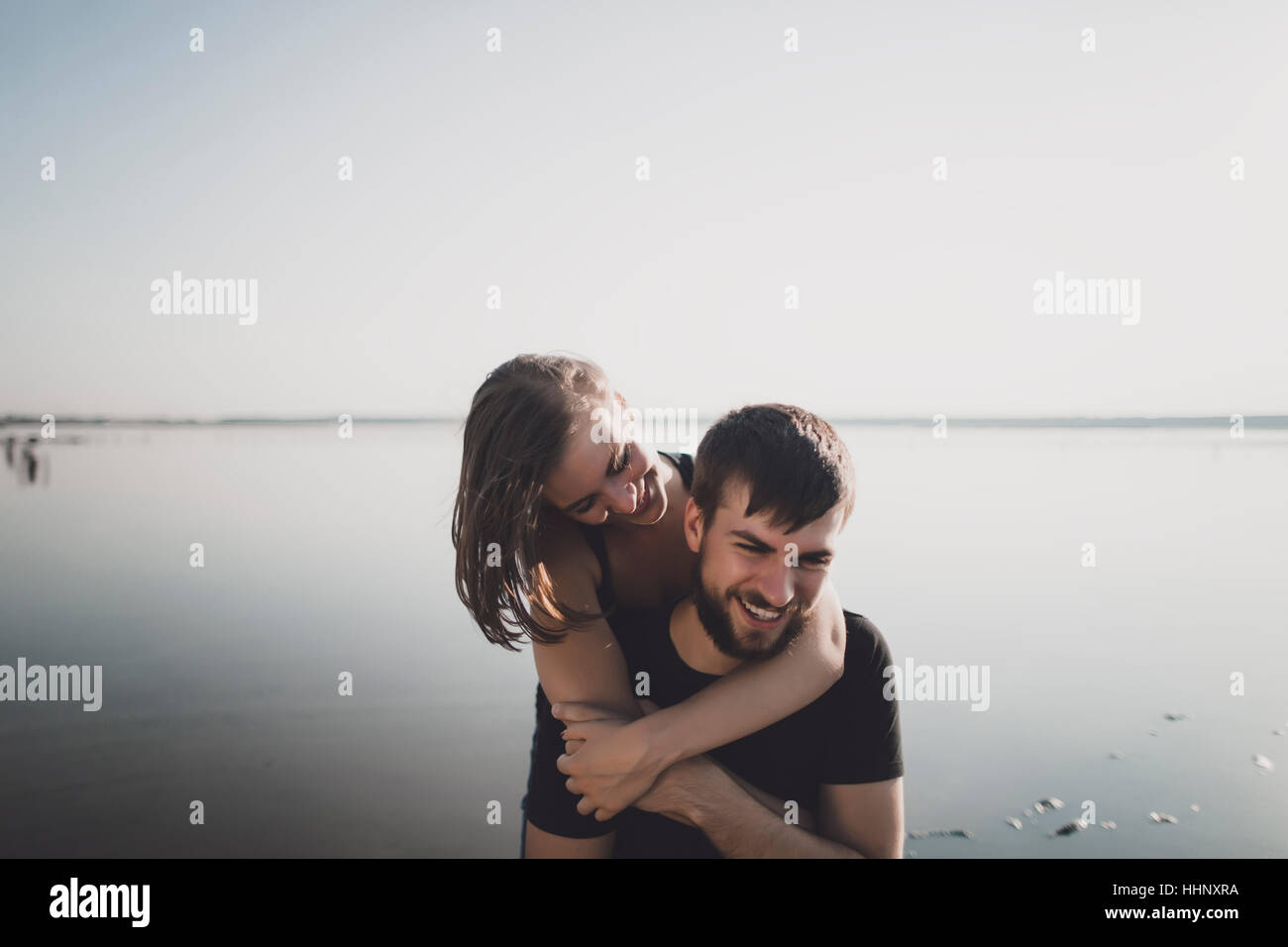 Hugging couple by lake hi-res stock photography and images - Alamy