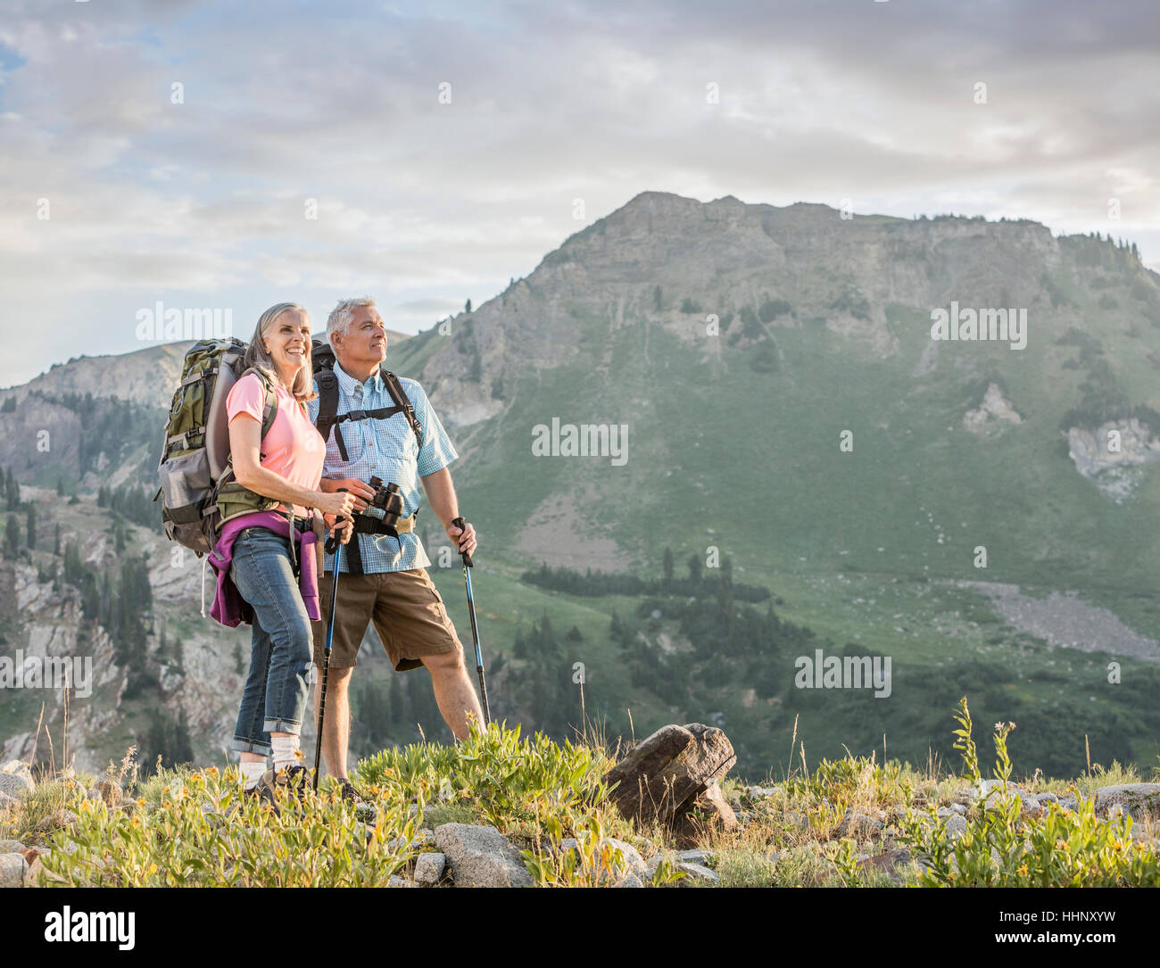 Caucasian couple hiking on mountain Stock Photo