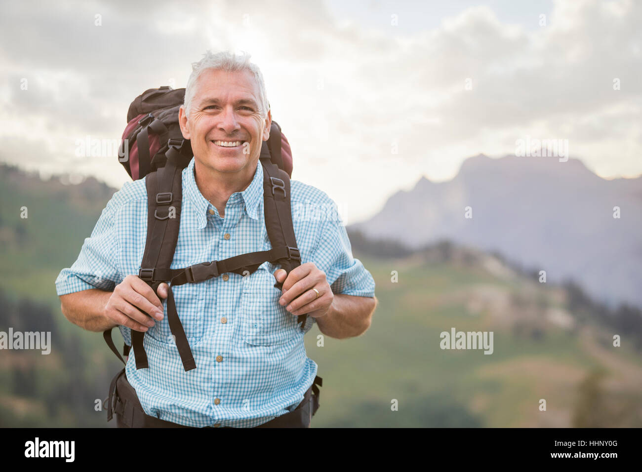 Caucasian man hiking on mountain Stock Photo - Alamy