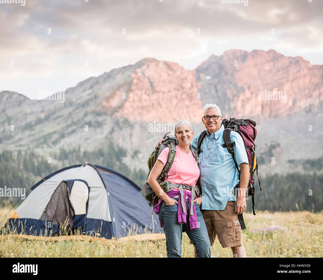 Caucasian couple camping on mountain Stock Photo