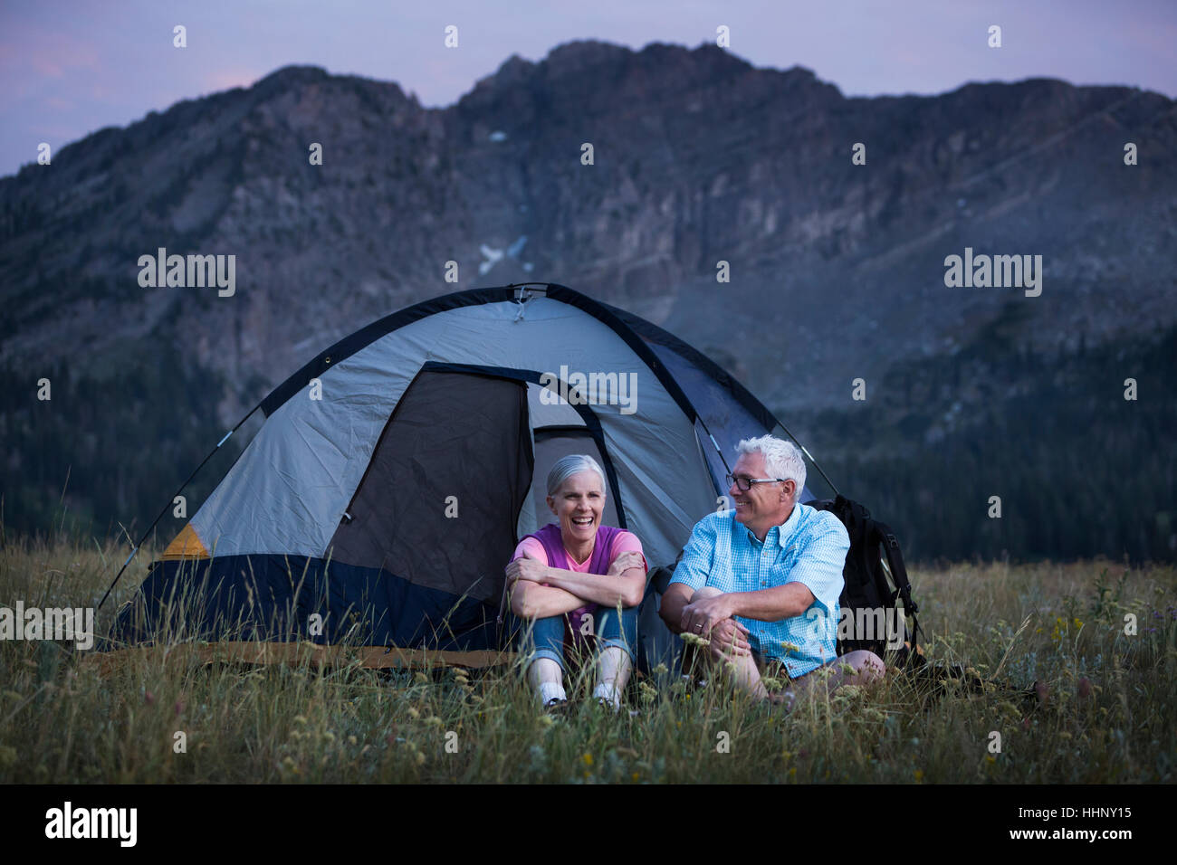 Caucasian couple camping on mountain Stock Photo