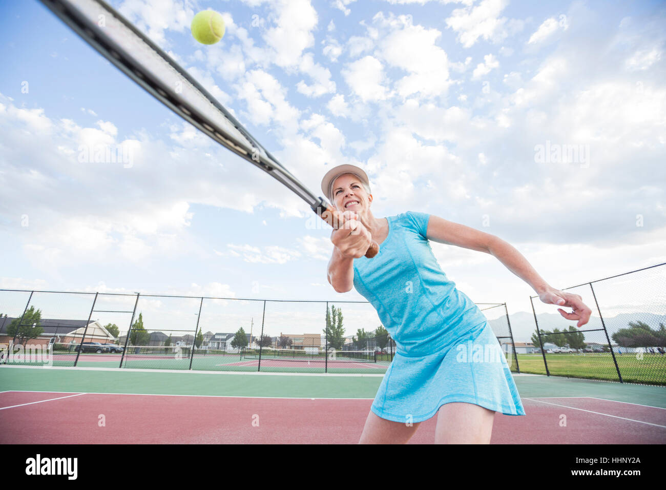 Caucasian woman hitting tennis ball Stock Photo Alamy